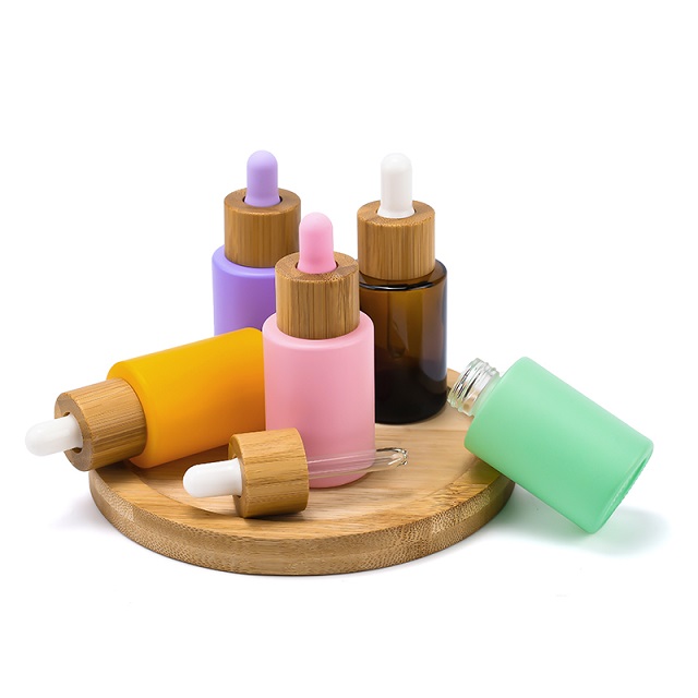 주문 로고 100ml 무광택 유리 화장품 포장 15ml 20ml 30ml 50ml 대나무 점적기 모자를 가진 둥근 유리제 머리 얼굴 정유 병