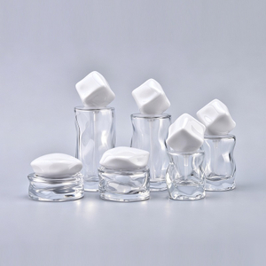 Tarro de crema de vidrio transparente de forma &uacute;nica de lujo con tapa atornillada 30 g 50 ml 100 ml 120 ml Suero para el cuidado de la piel y botella de embalaje cosm&eacute;tico